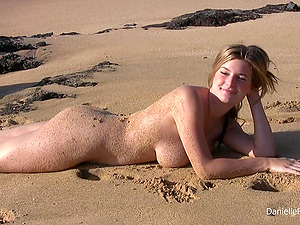 All natural Danielle shows her nude figure on a beach